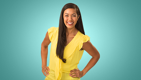 A woman in a bright yellow shirt on a blue background, with an open smile