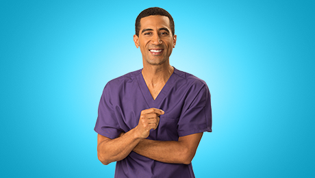 Male pharmacist in purple scrubs on blue background talking